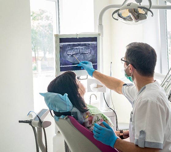 showing woman x-ray at dental exam in Austin