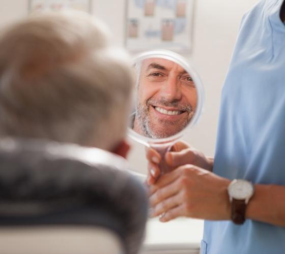 Man looking at his smile after smile makeover