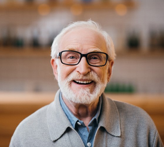 Senior man with beard and glasses smiling