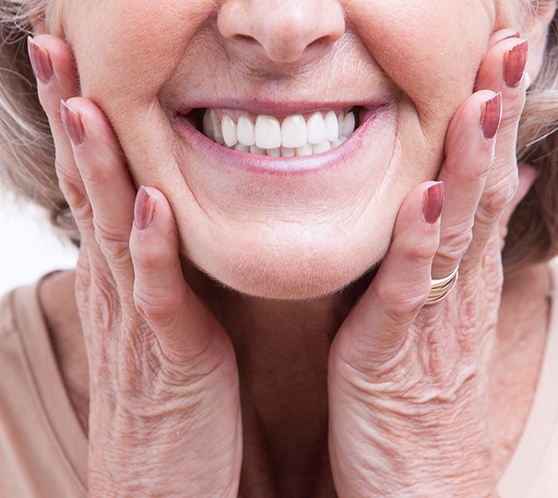 A close-up of a woman smiling with her dentures from Austin