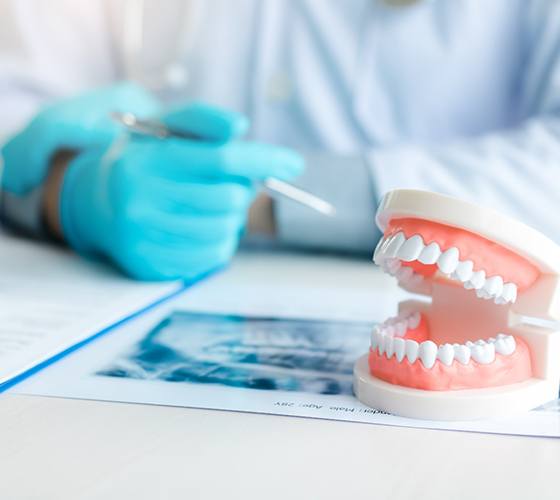 A dentist explaining dentures aftercare to a patient