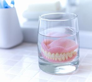 Dentures soaking in solution