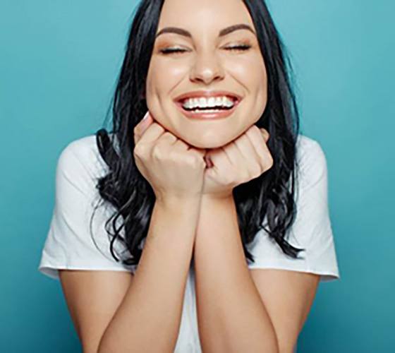 Woman smiling after visiting emergency dentist in Austin