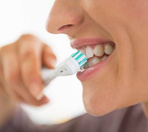 Woman brushing her teeth