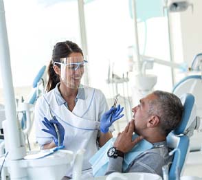 Implant dentist in Austin explaining treatment to patient