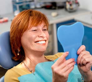 Woman smiling after getting dental implant in Austin