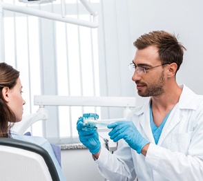 Dentist explaining how dental implants work in Austin to patient