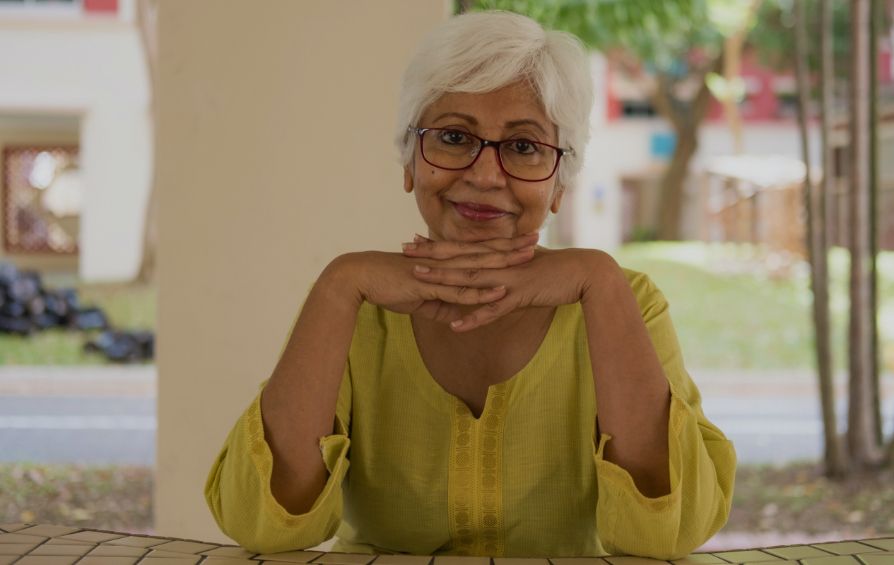 Older woman smiling and sitting at table