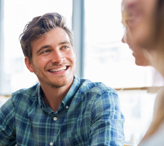 man smiling while wearing Invisalign in Austin