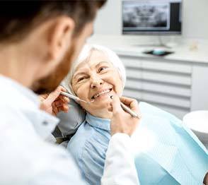 Implant dentist in Austin performing a routine exam