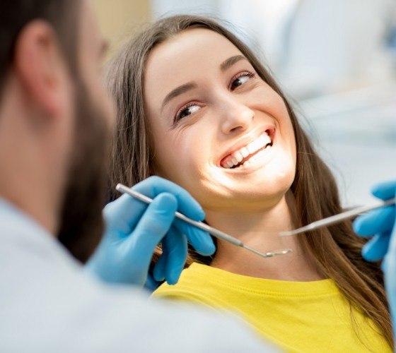 Woman receiving preventive dentistry checkup and teeth cleaning