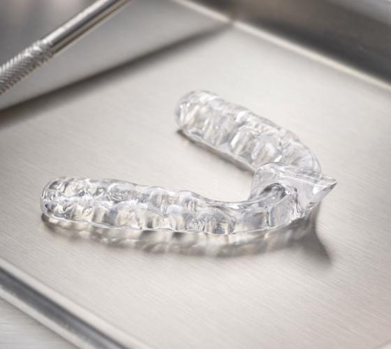 Clear nightguard for teeth grinding on metal tray