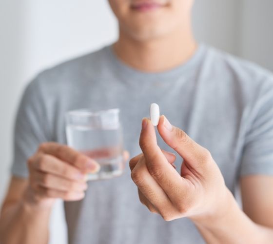 Patient holding an oral conscious dental sedation pill