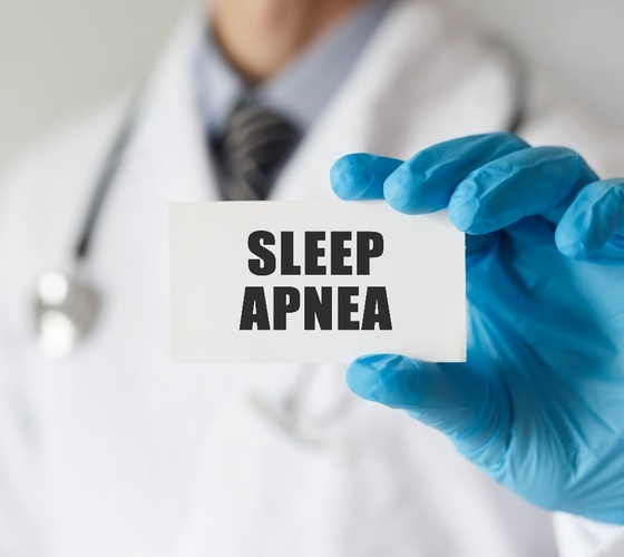Medical professional holding card that says sleep apnea
