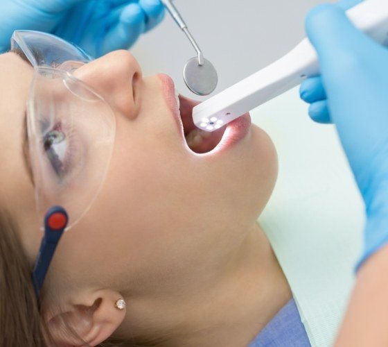 Dentist using intraoral camera to capture smile images