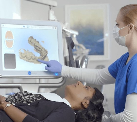 patient laying down and dentist looking at xrays