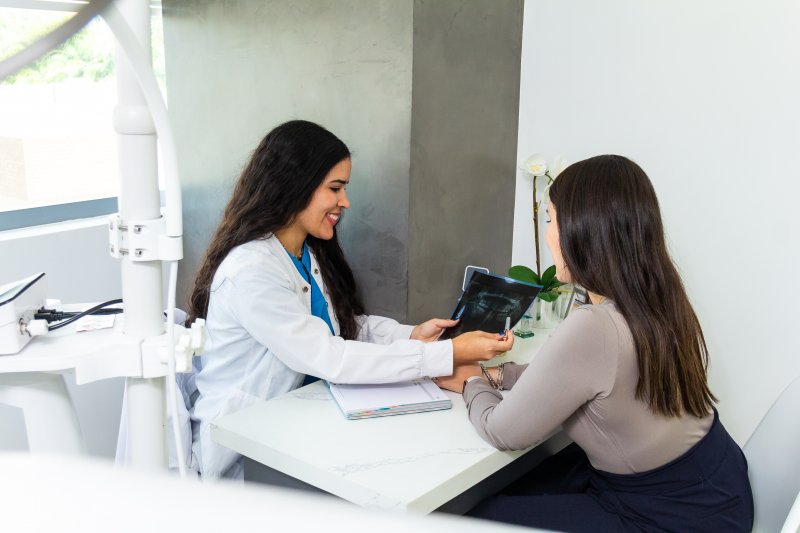 dentist talking to a female patient